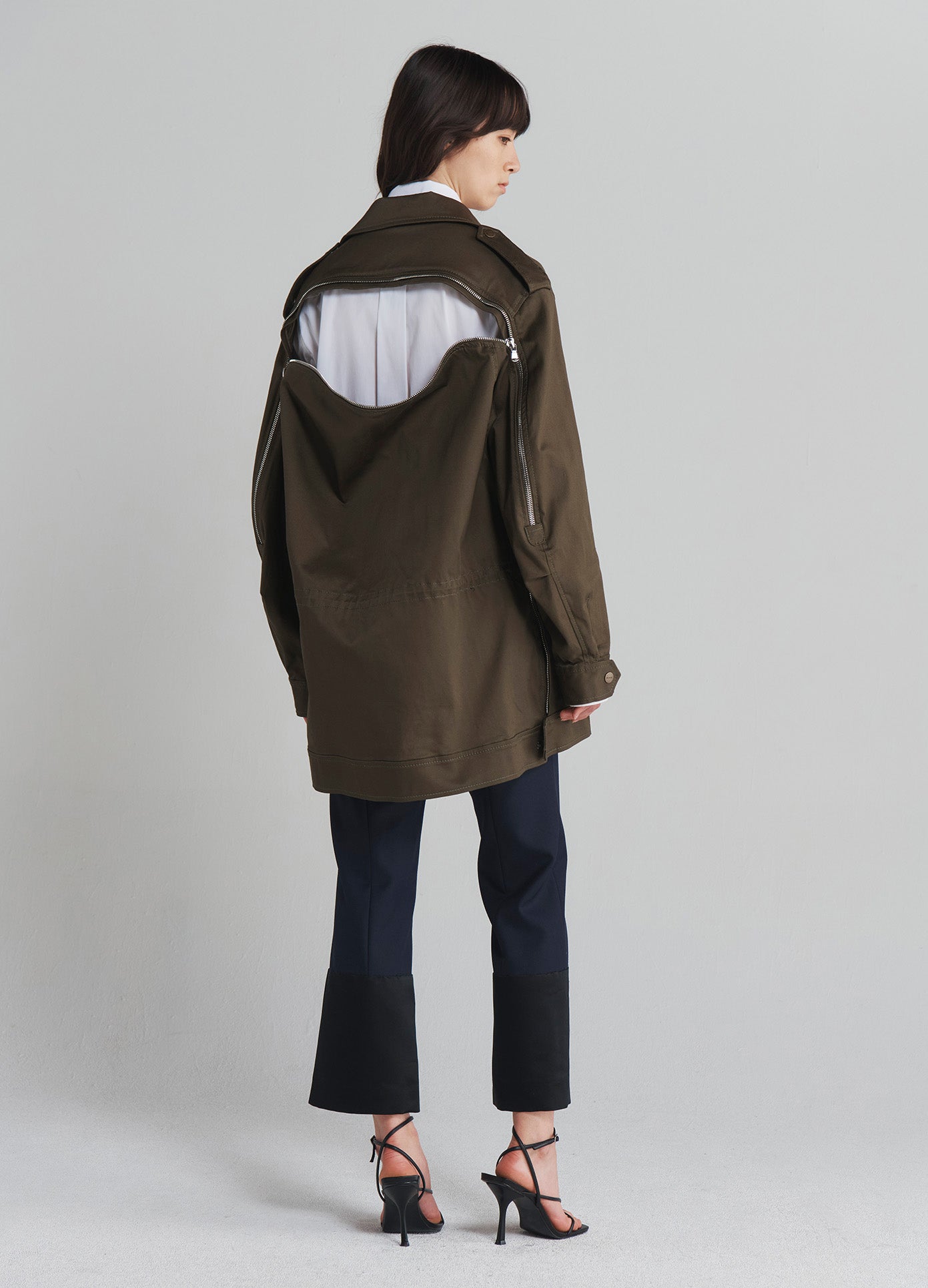 MONSE Utility Jacket in Olive on model with jacket unzipped full back view