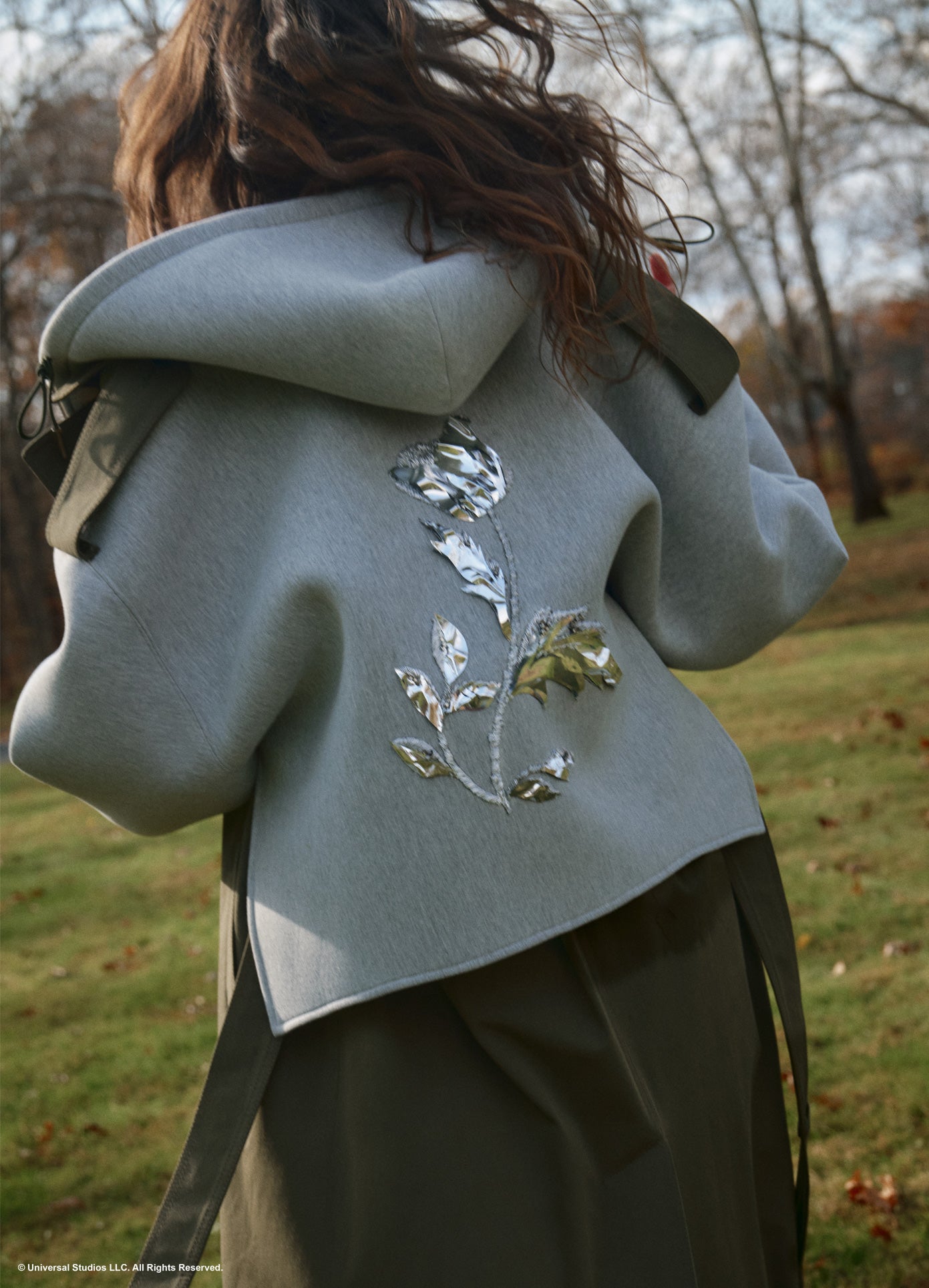 MONSE x Wicked Collaboration Oversized Emerald Hooded Trench in olive and grey on model back view lifestyle image