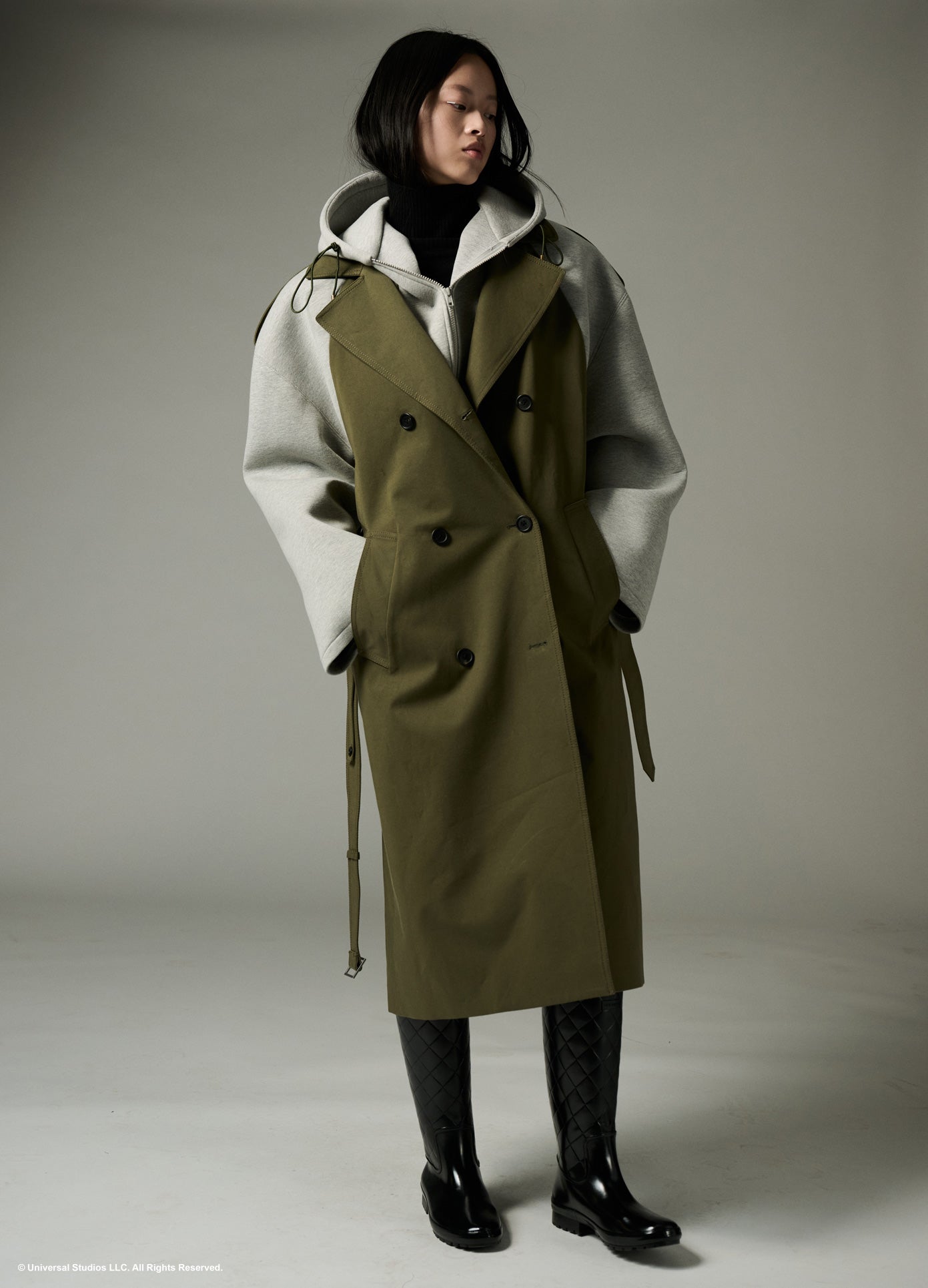 MONSE x Wicked Collaboration Oversized Emerald Hooded Trench in olive and grey on model looking left full front view