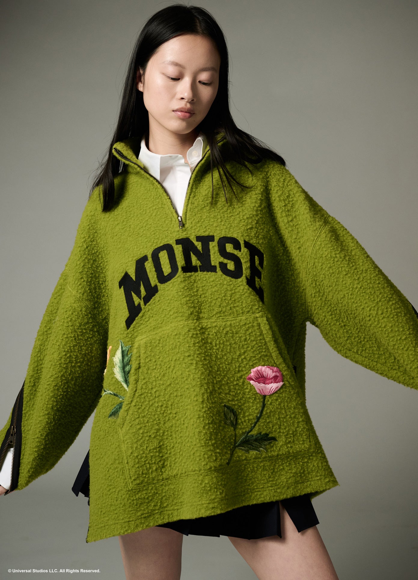 MONSE x Wicked Collaboration Oz Varsity Fleece in green on model looking down front view
