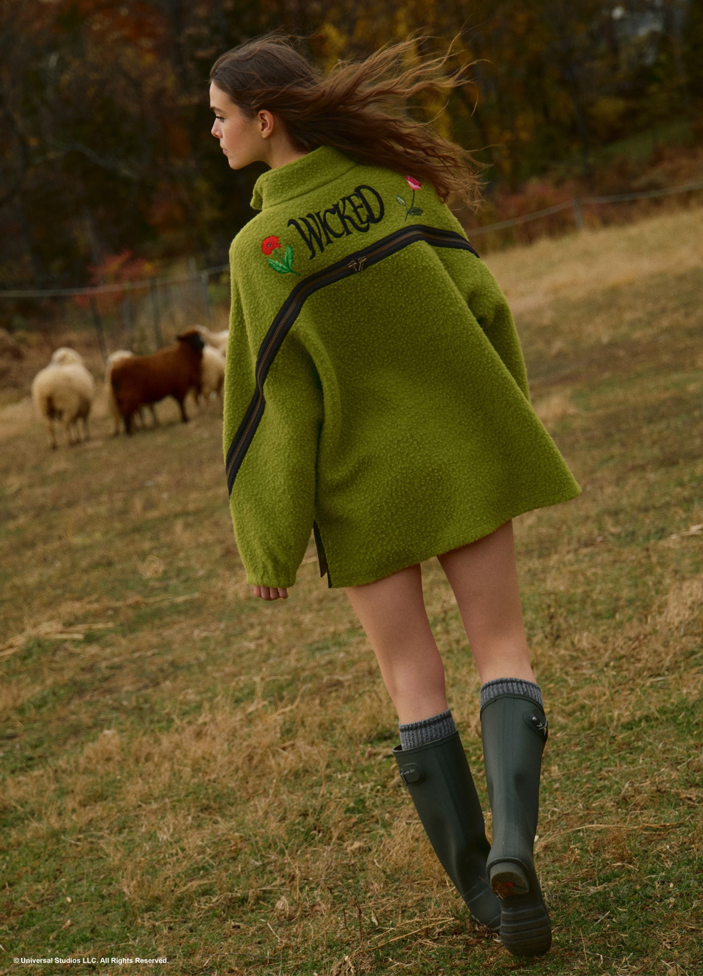 MONSE x Wicked Collaboration Oz Varsity Fleece in green on model walking lifestyle image