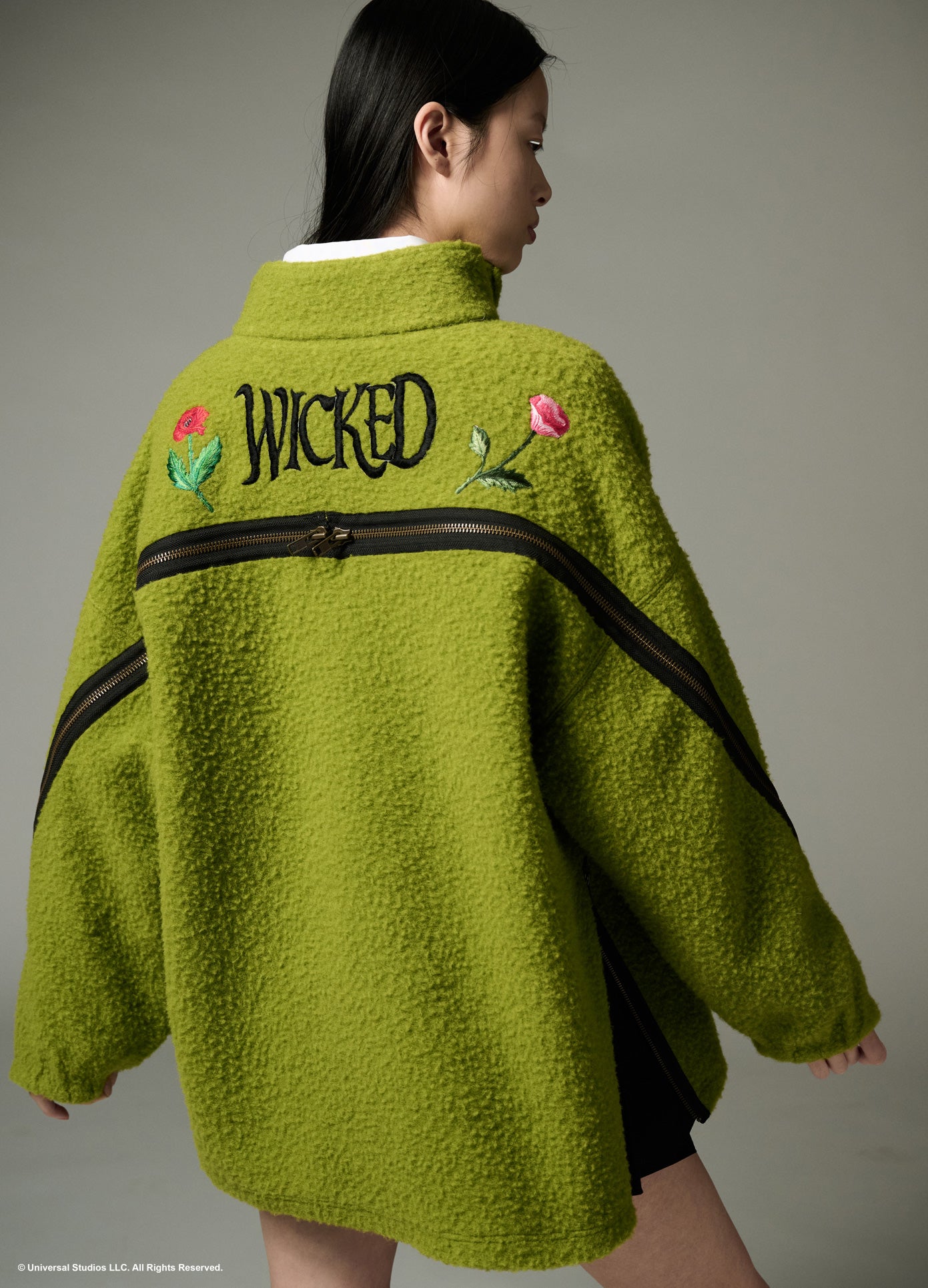 MONSE x Wicked Collaboration Oz Varsity Fleece in green on model zipped up zoomed out back view