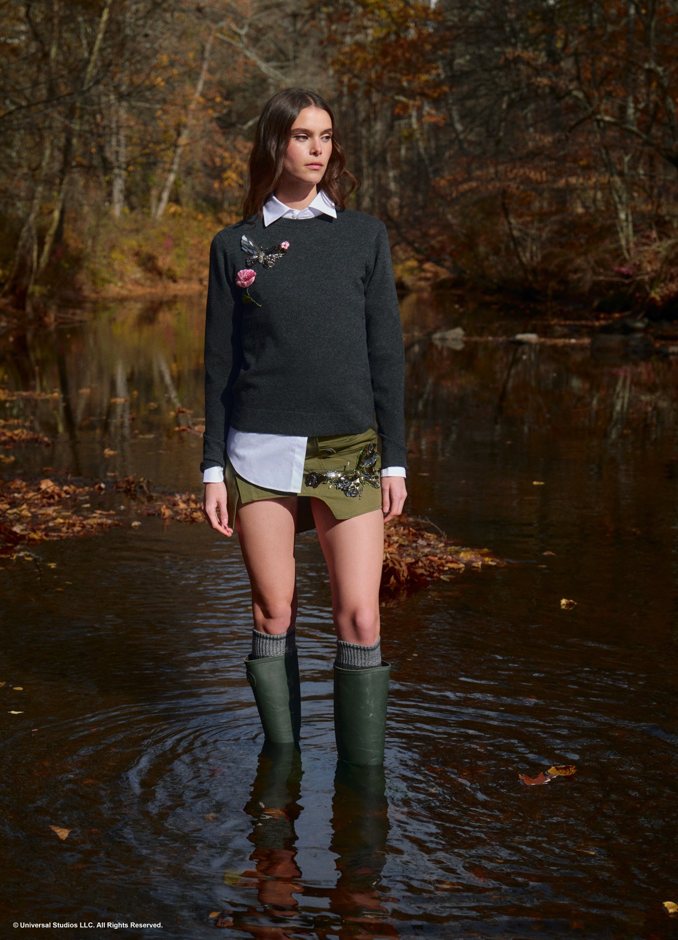 MONSE x Wicked Collaboration The Monarch Skirt in olive on model standing in creek full front view lifestyle image