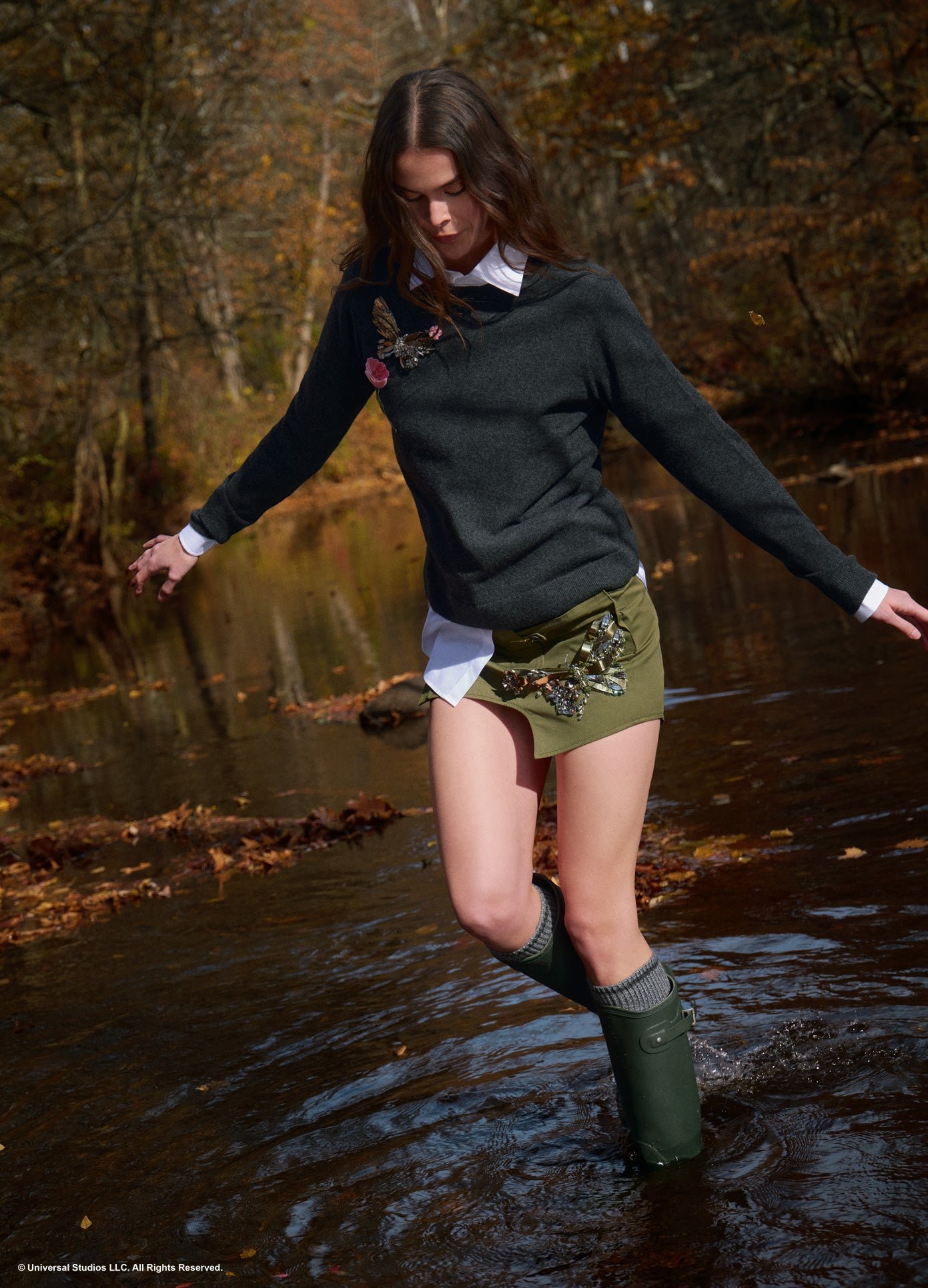 MONSE x Wicked Collaboration The Monarch Skirt in olive on model walking in creek full front view lifestyle image