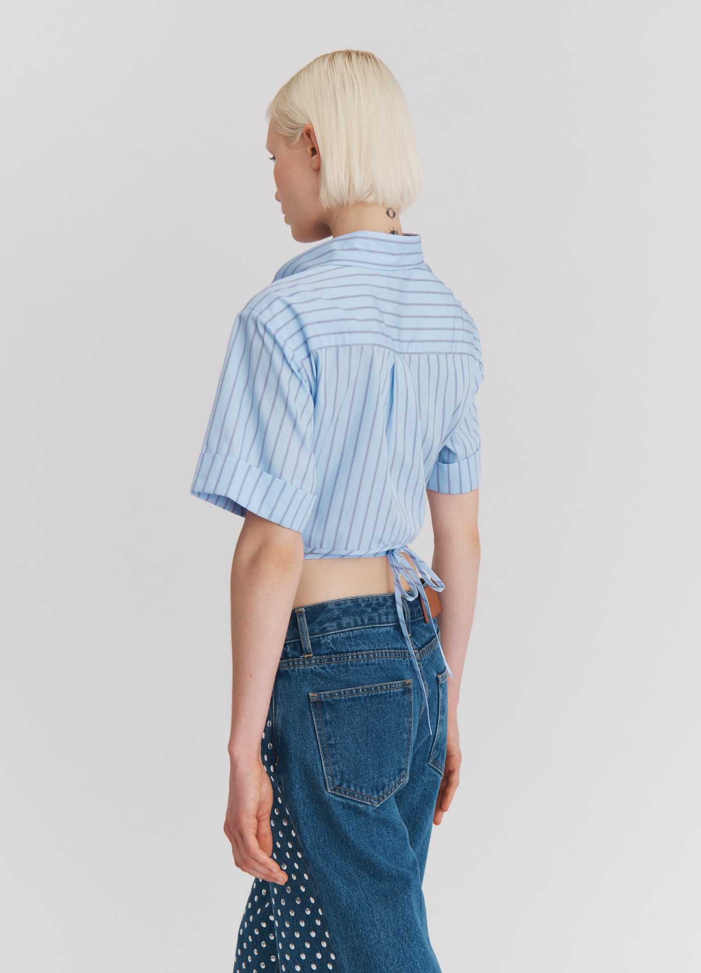 MONSE Wrap Cropped Shirt in Midnight Stripe on model walking back view