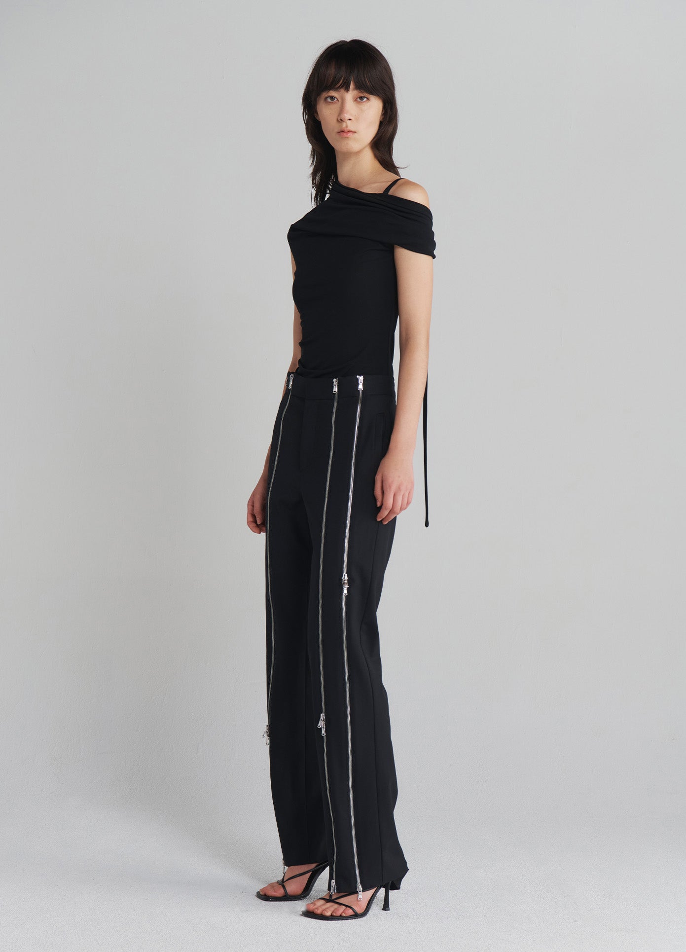 MONSE Zippered Tailored Trousers in Black on model full side view