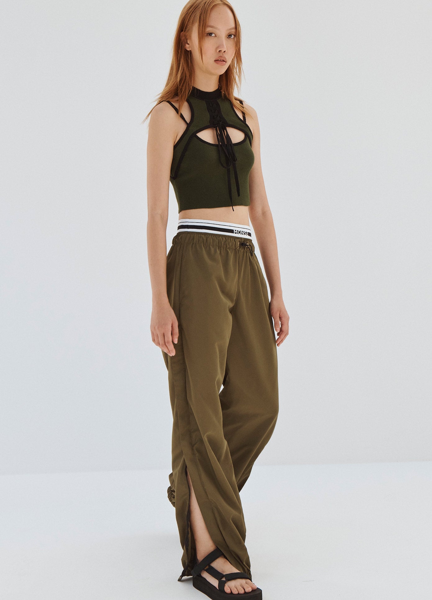 MONSE Double Waistband Track Pants in Olive on Model Walking Angled Full Front View