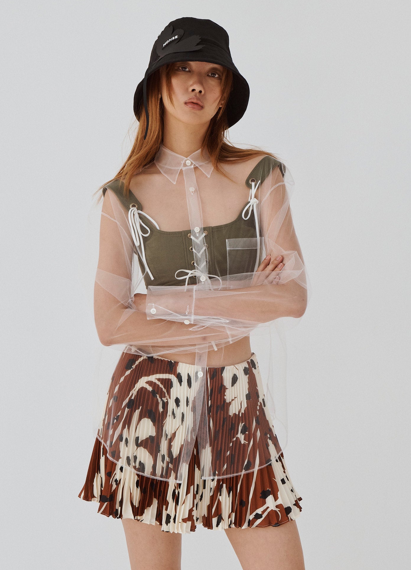 MONSE Floral Pleated Mini Skirt in Brown Multi on Model Arms Crossed Front View