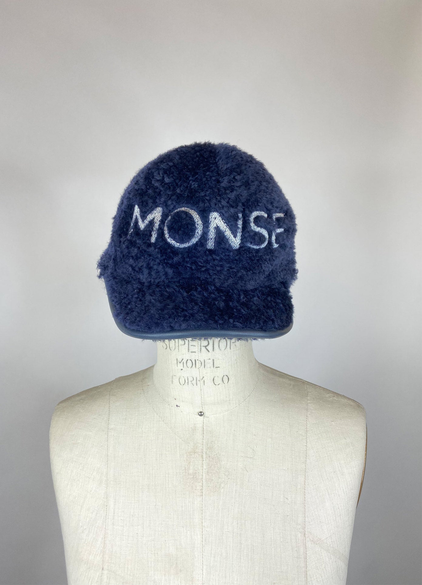 MONSE Fur Baseball Cap in Midnight on Mannequin Head Front View