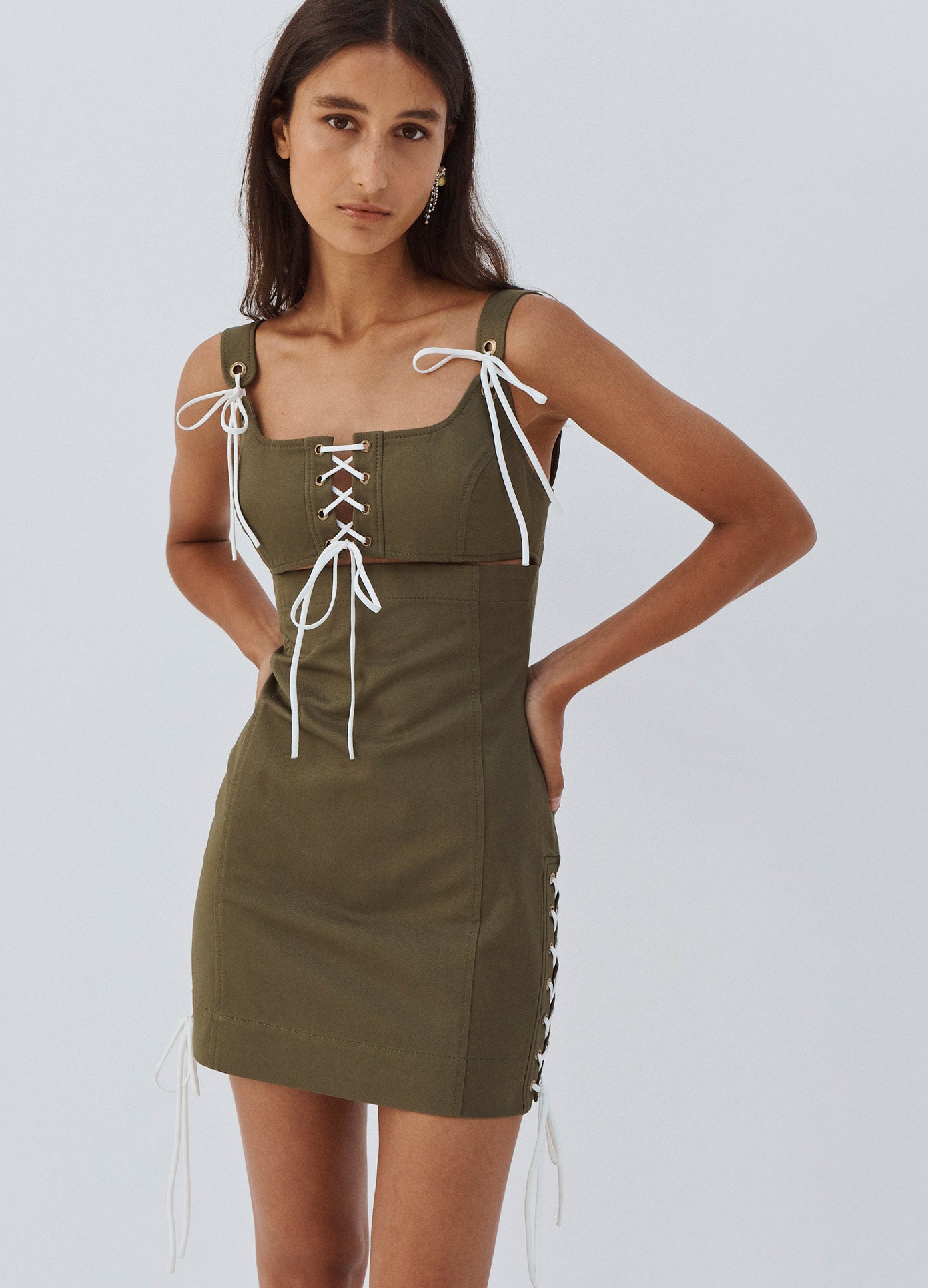 MONSE Laced Detail Mini Dress in Olive on Model Hands on Hips Front View