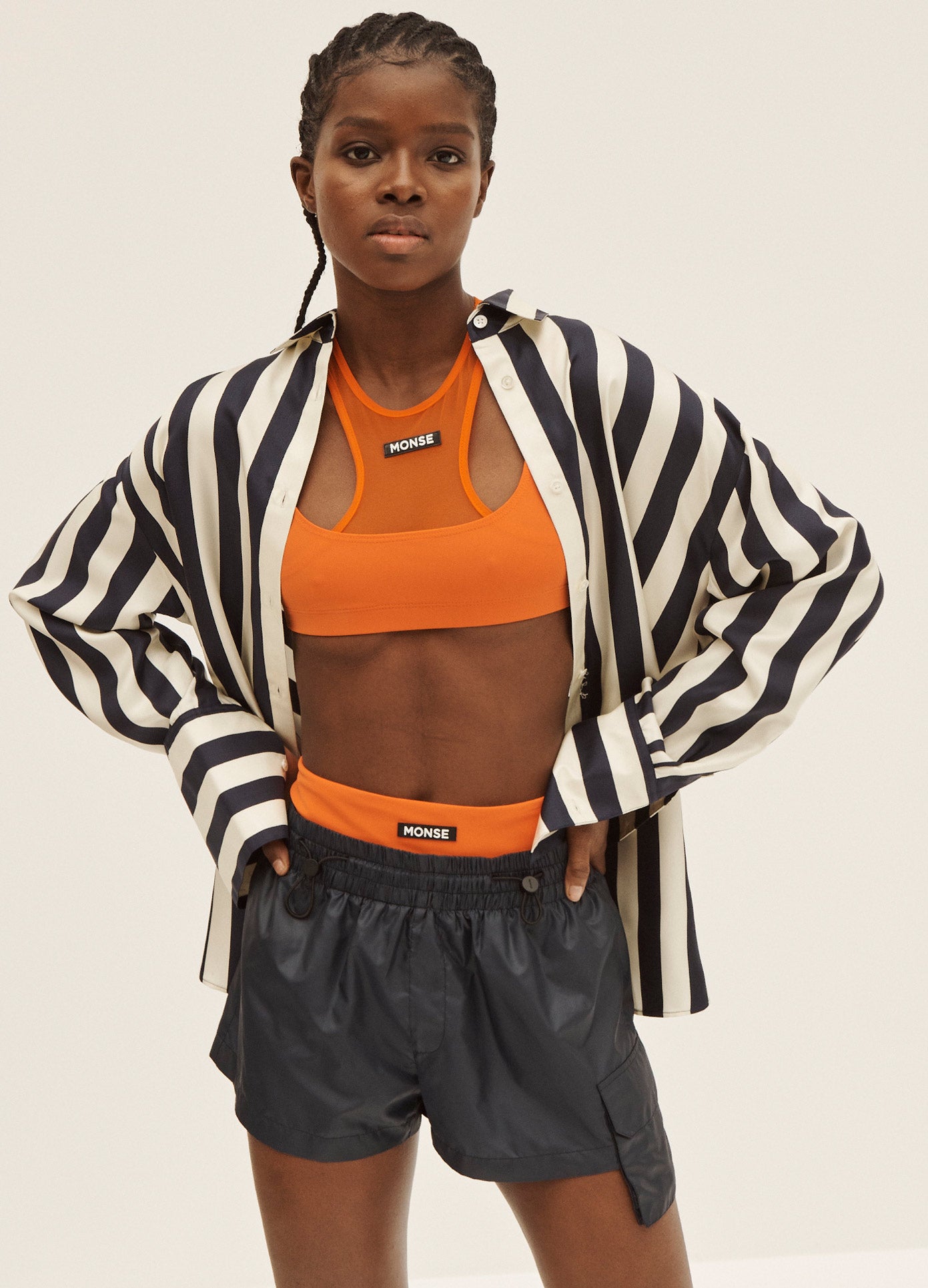 MONSE Layered Short in Midnight and Deep Orange on Model with Hands on Hips Front View