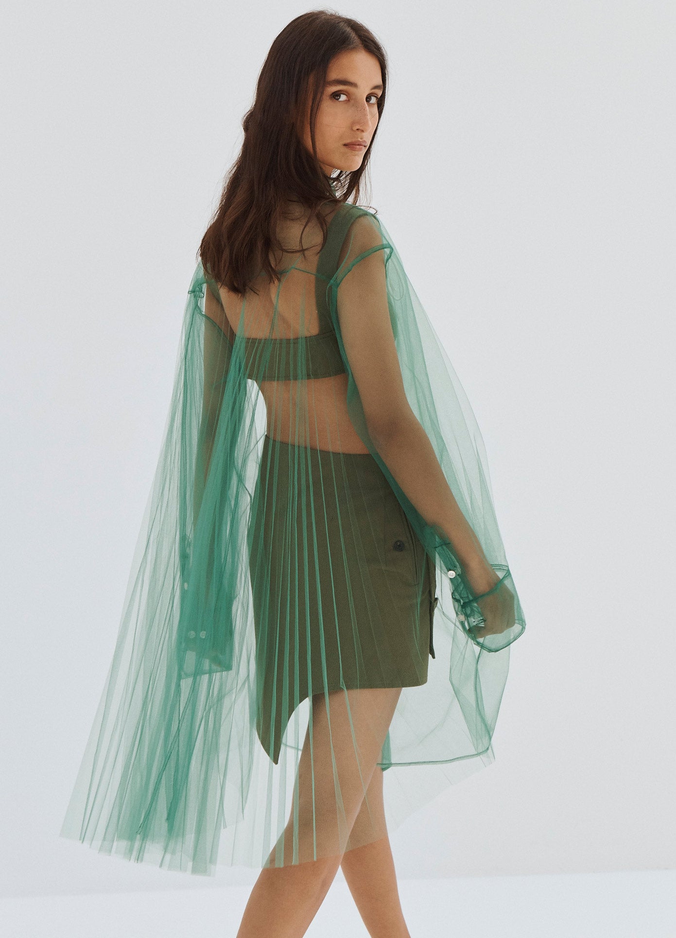 MONSE Pleated Back Button Down Tulle Shirt in Green on Model Walking Away Back View
