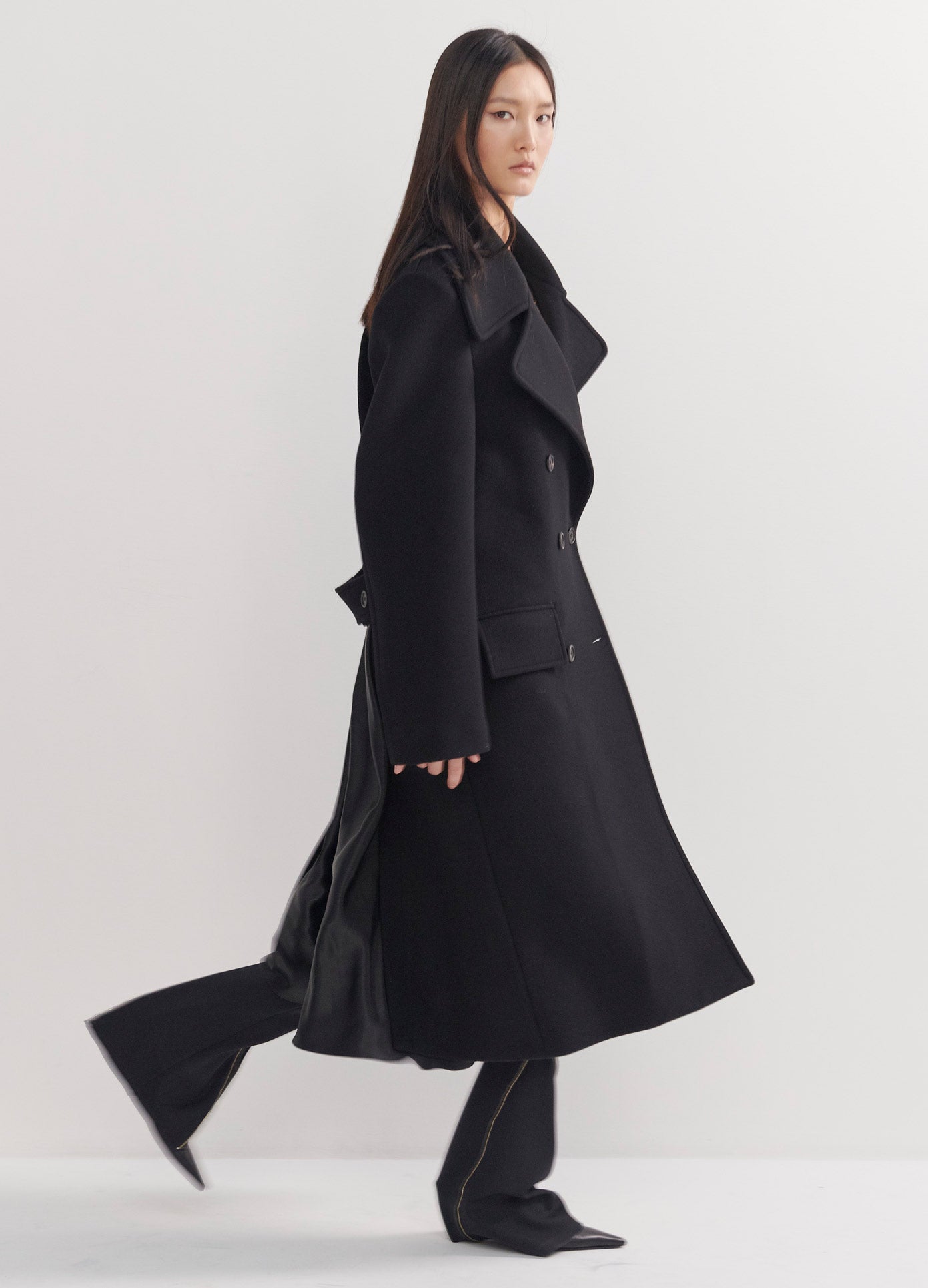 MONSE Satin Back Inset Coat in Black on Model Walking Side View