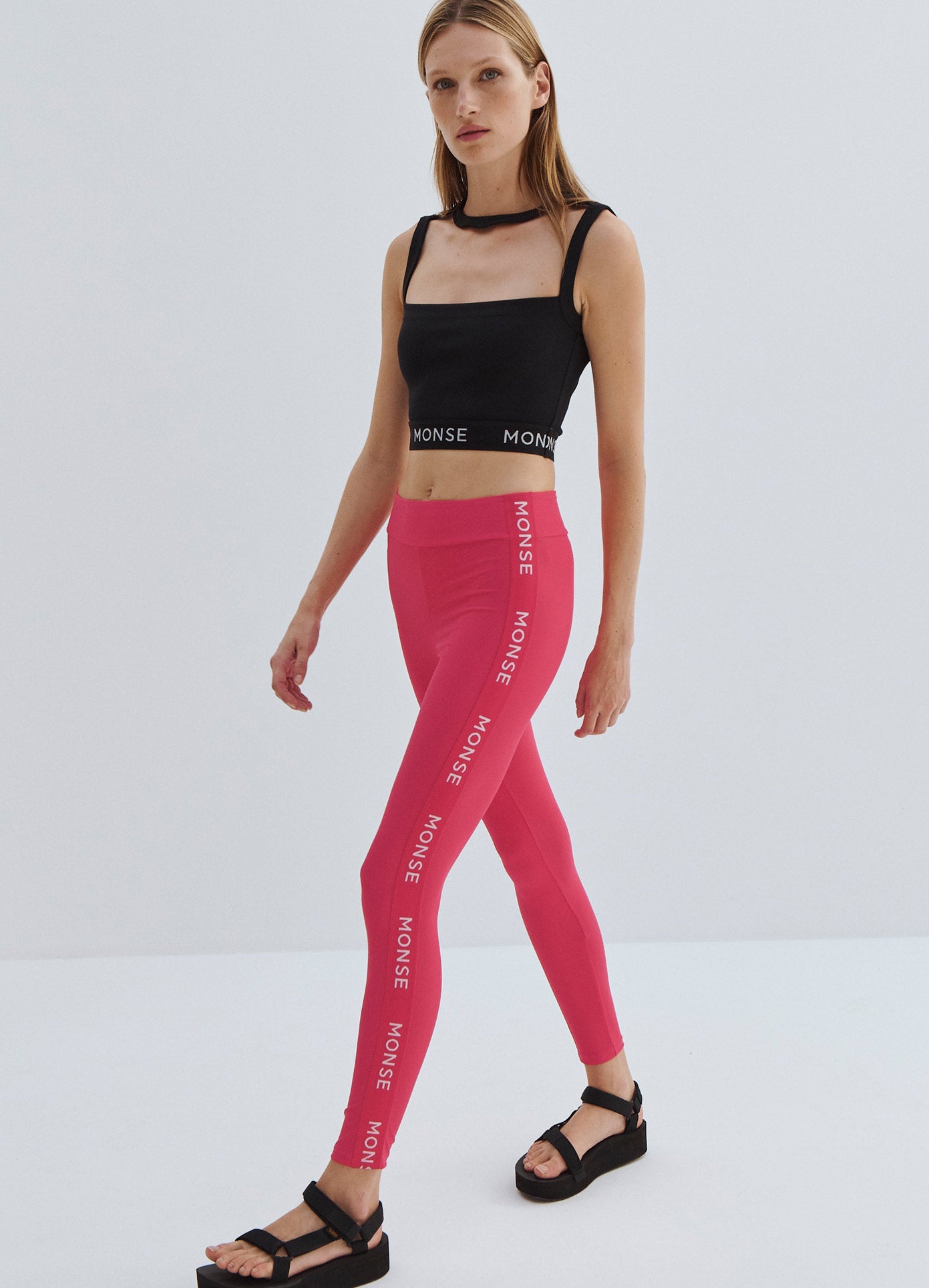 MONSE Side Logo Leggings in Raspberry on Model Walking Full Front Side View