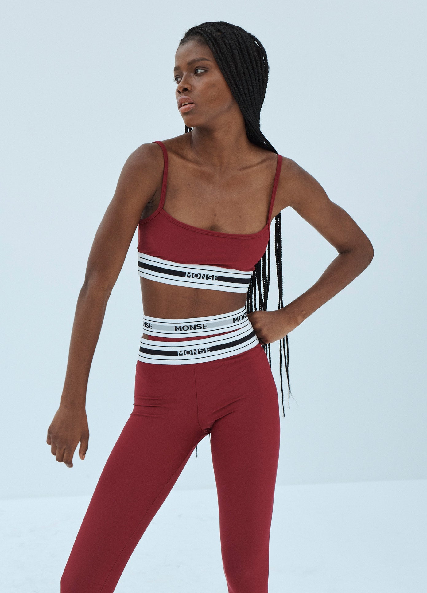 MONSE Sports Bra in Ruby on Model Hand on Hip Front View