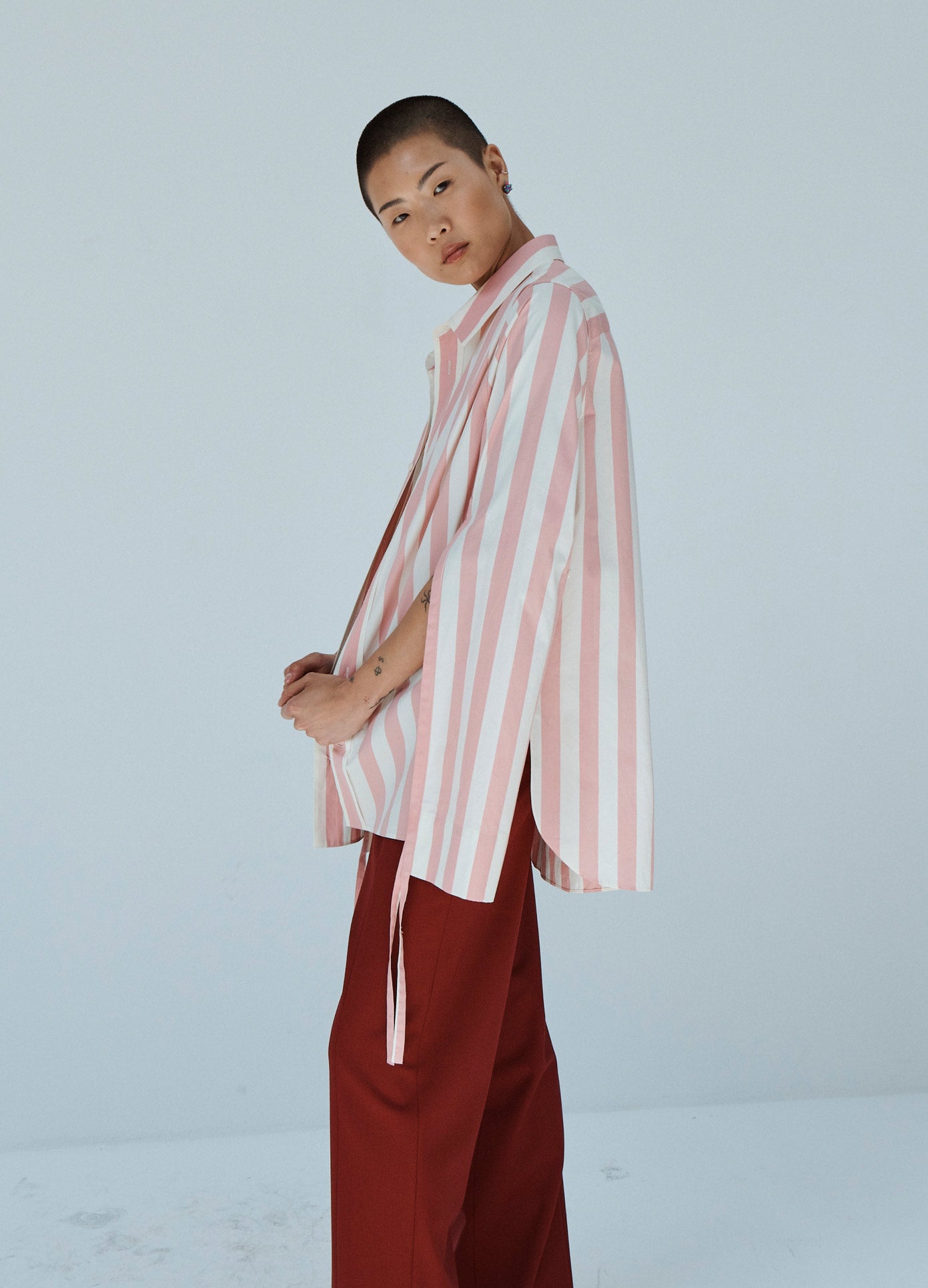 MONSE Striped Long Sleeve Shirt in Pink and Ivory on Model Side View
