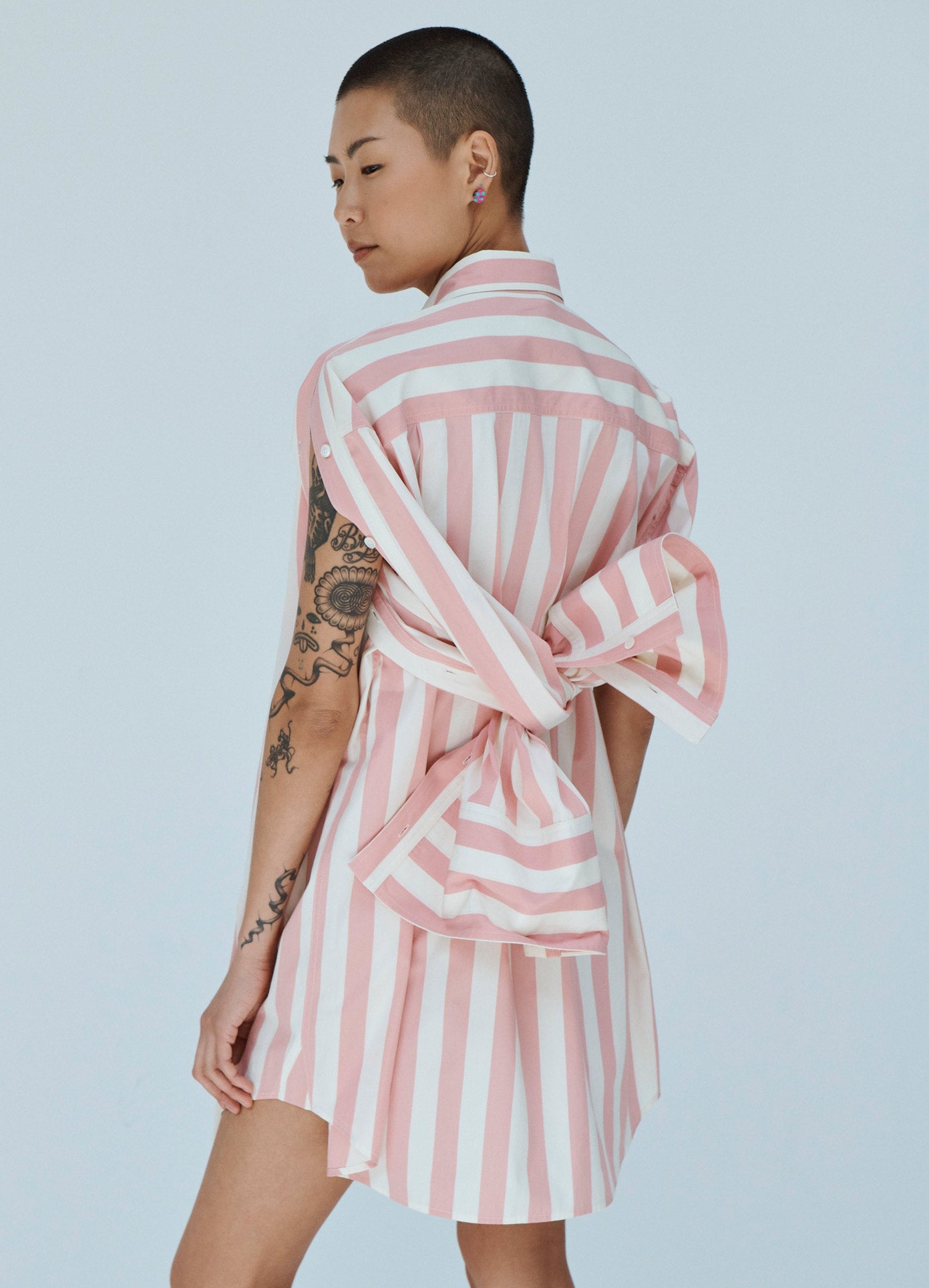 MONSE Striped Tie Back Sleeve Shirt Dress in Pink and Ivory Sleeves Tied on Model Back View