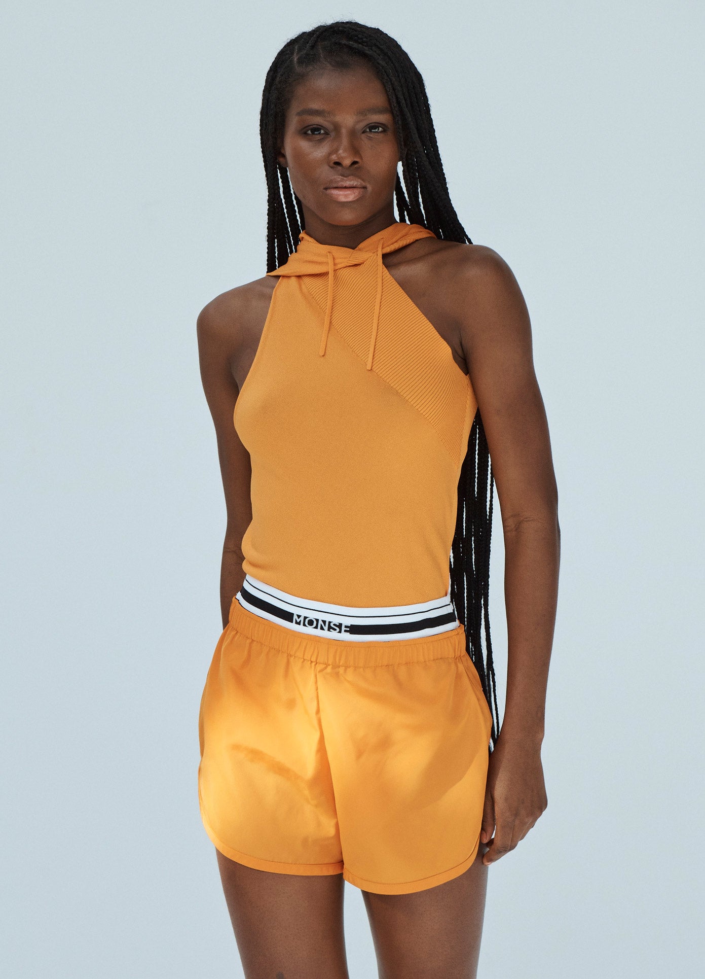 MONSE Techno Shorts with Waistband Detail in Orange on Model Front View
