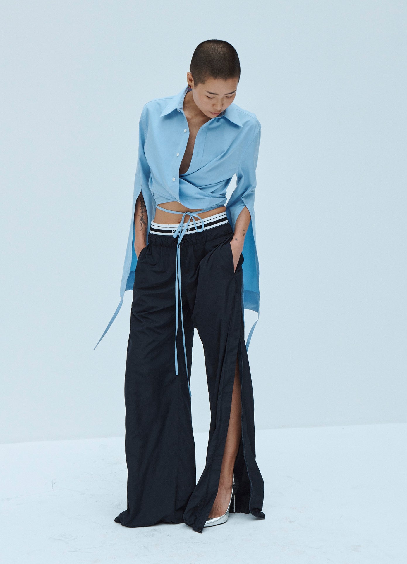 MONSE Techno Waistband Detail Parachute Pant in Black on Model Looking Down Front View