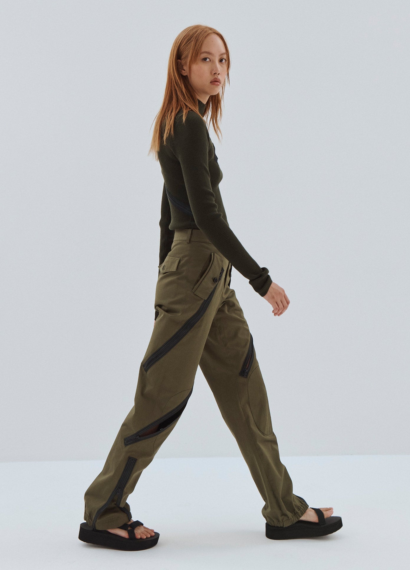 MONSE Zipper Detail Cargo Pants in Olive on Model Walking Side View